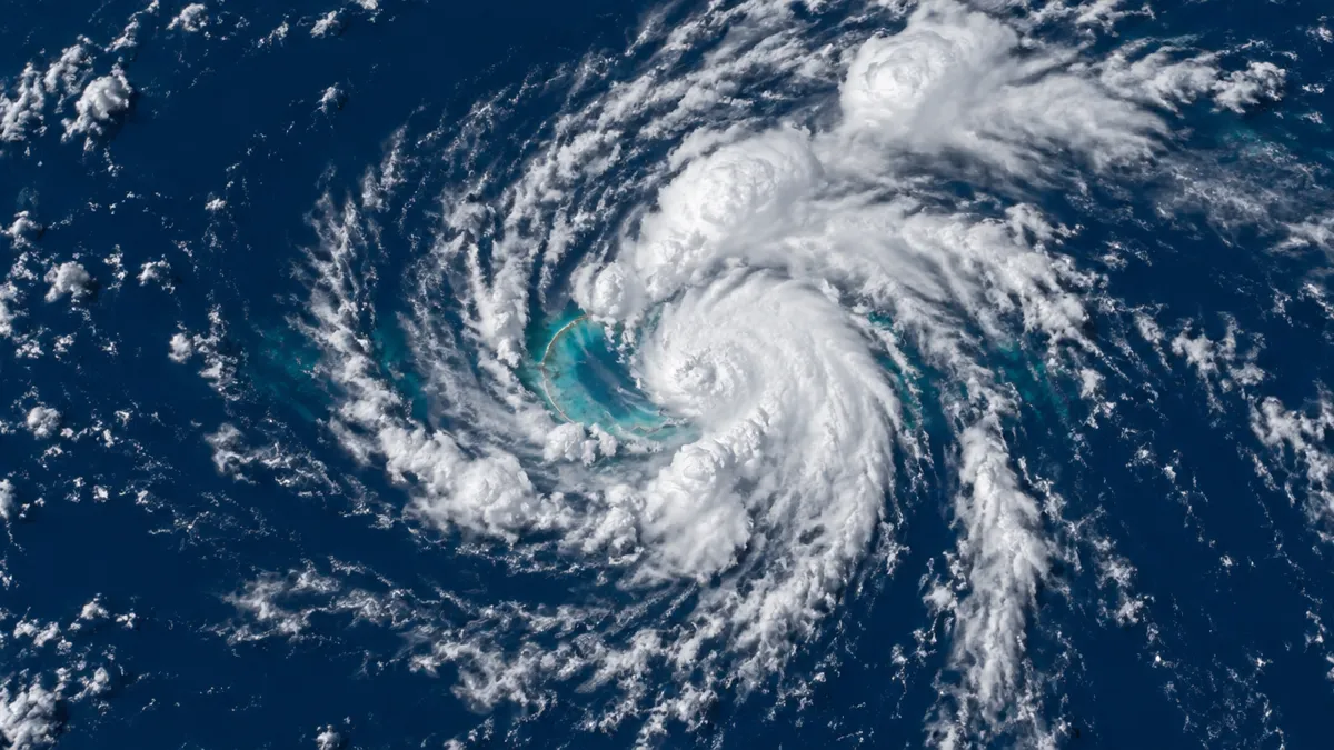 A young tropical cyclone over a coral atoll in the Pacific seen from orbit